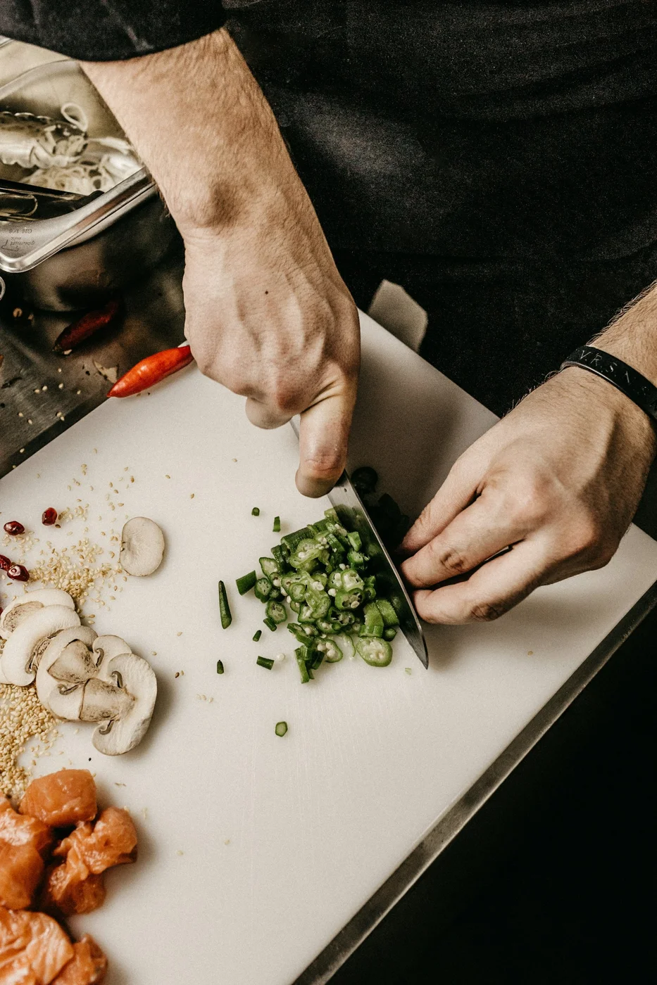 Hands preparing fresh vegetables on a cutting board