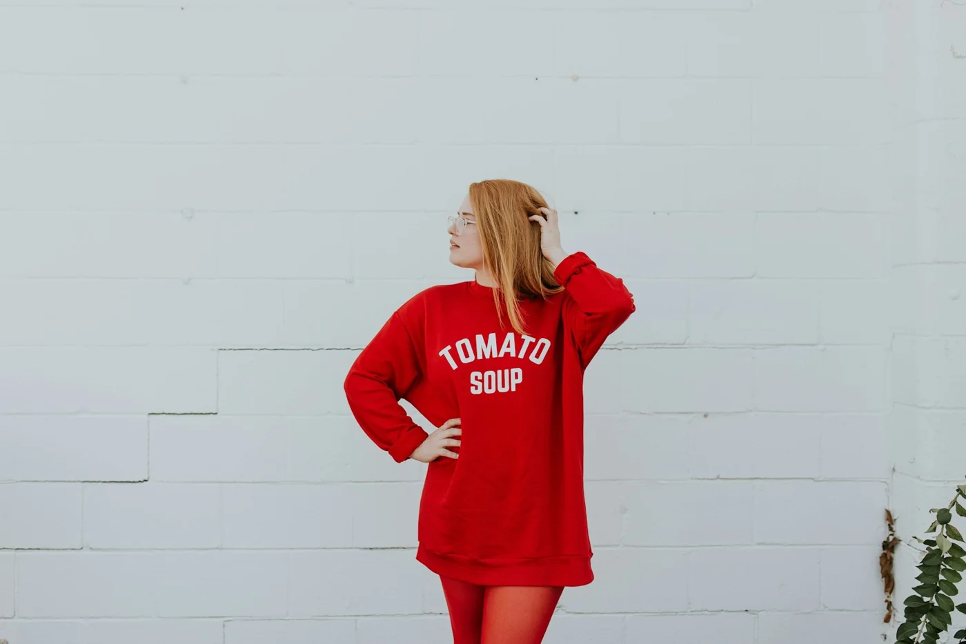 A woman wearing a red sweatshirt in an outdoor setting
