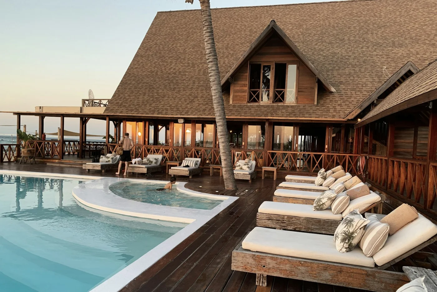 A waterside resort with loungers and a swimming pool